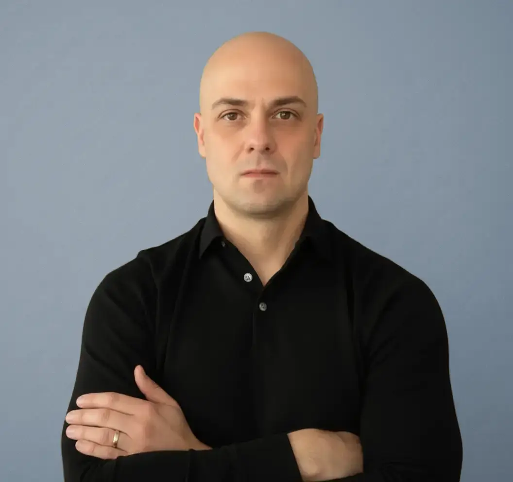 Headshot of Cris Tantillo, the founder of Corridor Industries. Black polo, arms crossed.