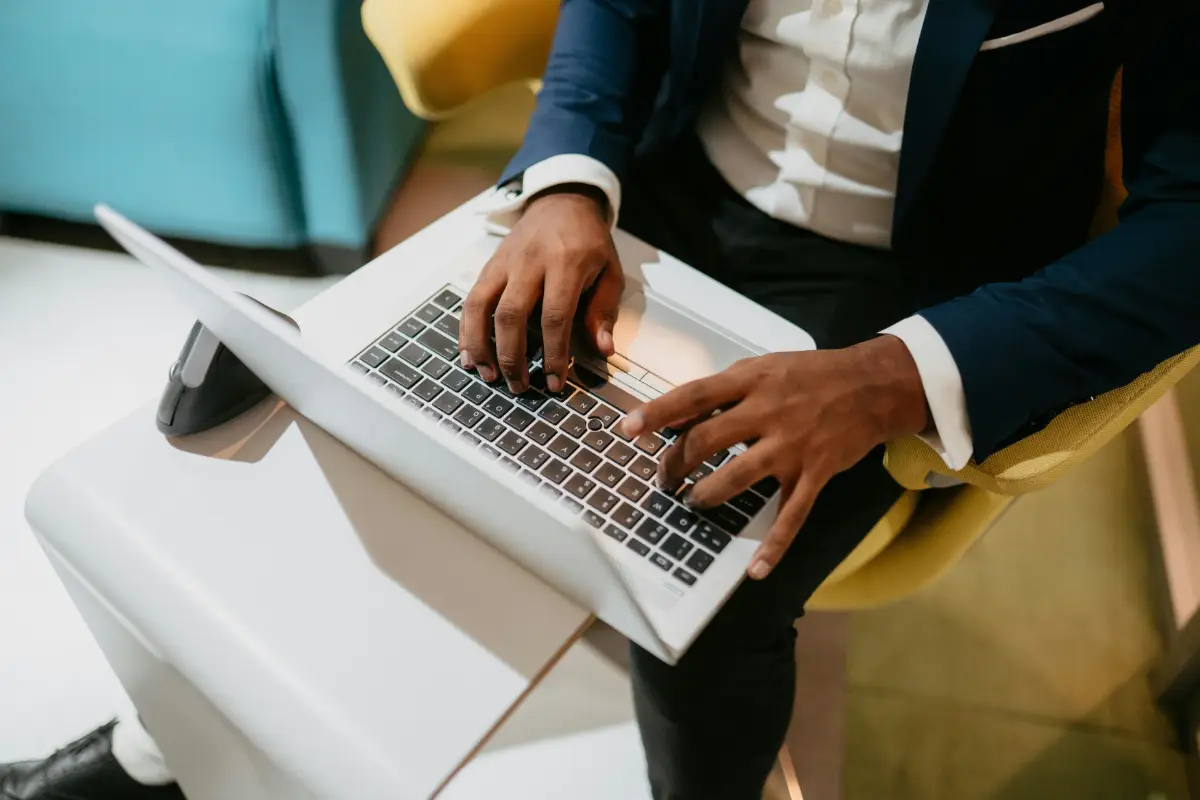 Businessman in suit typing on a laptop
